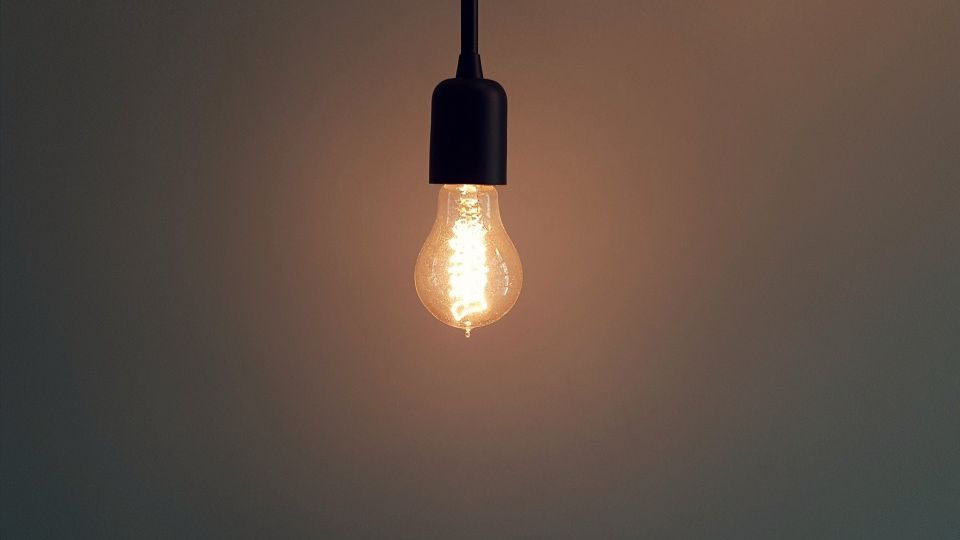 A lightbulb hanging from a wire and lit