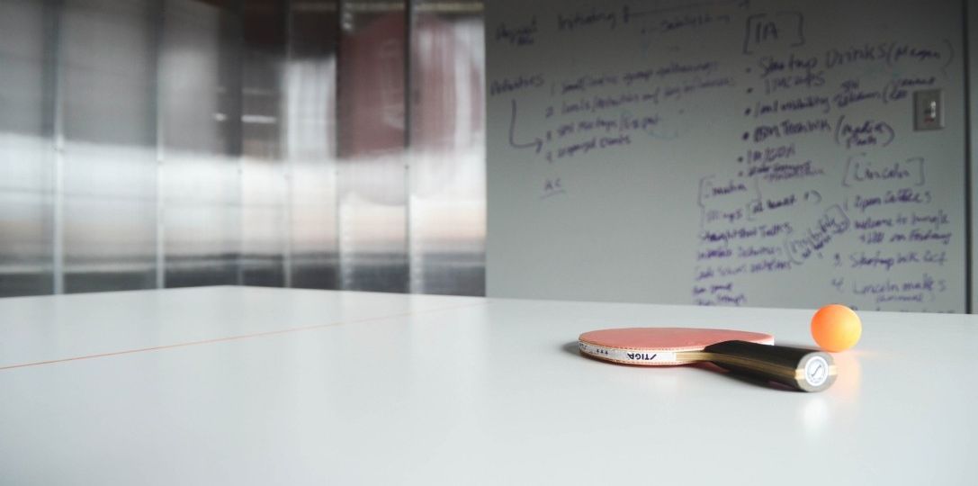 Ping pong ball and racket on work desk