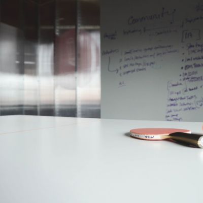 Ping pong ball and racket on work desk